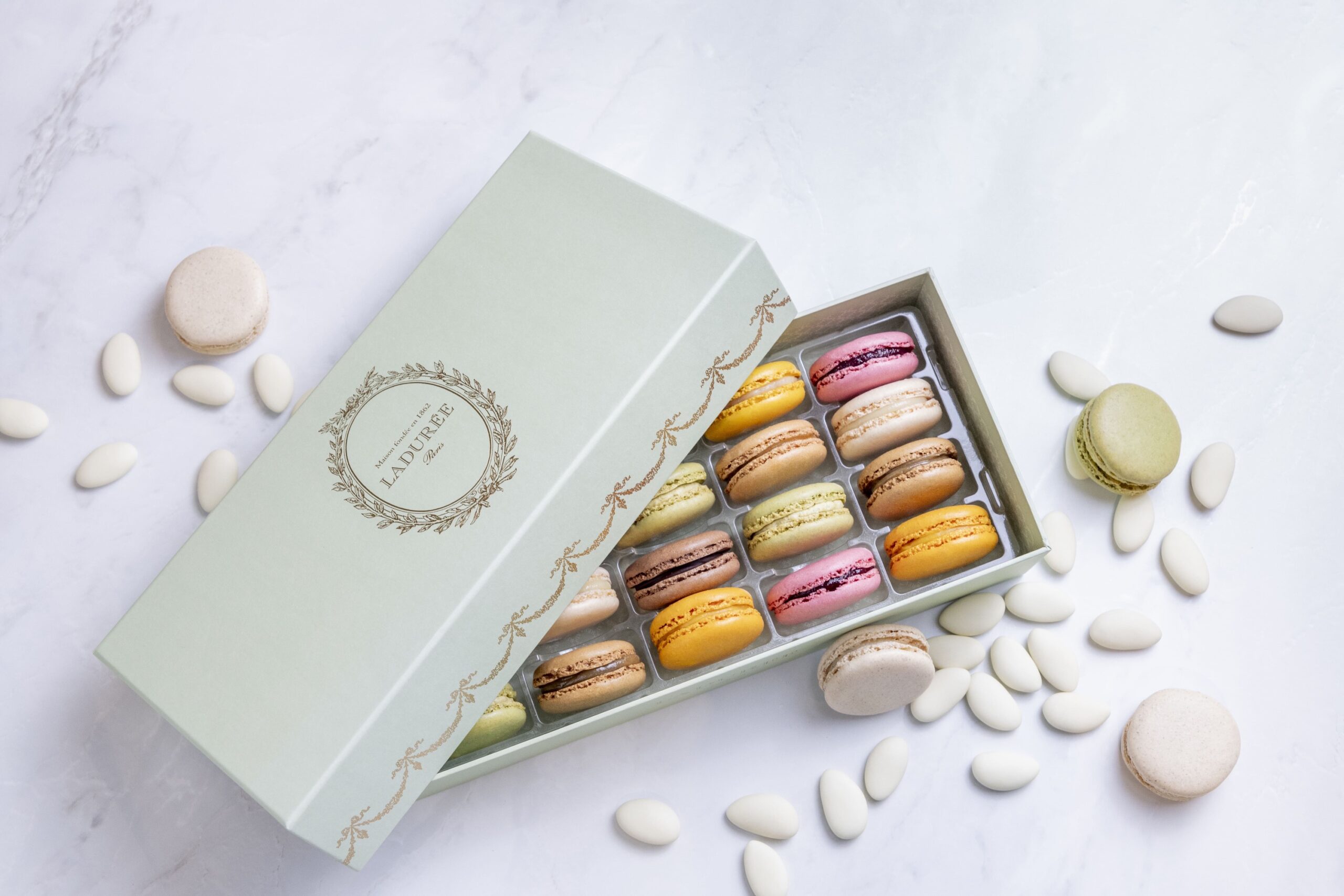 Box of macarons scattered with sugared almonds, Ladurée