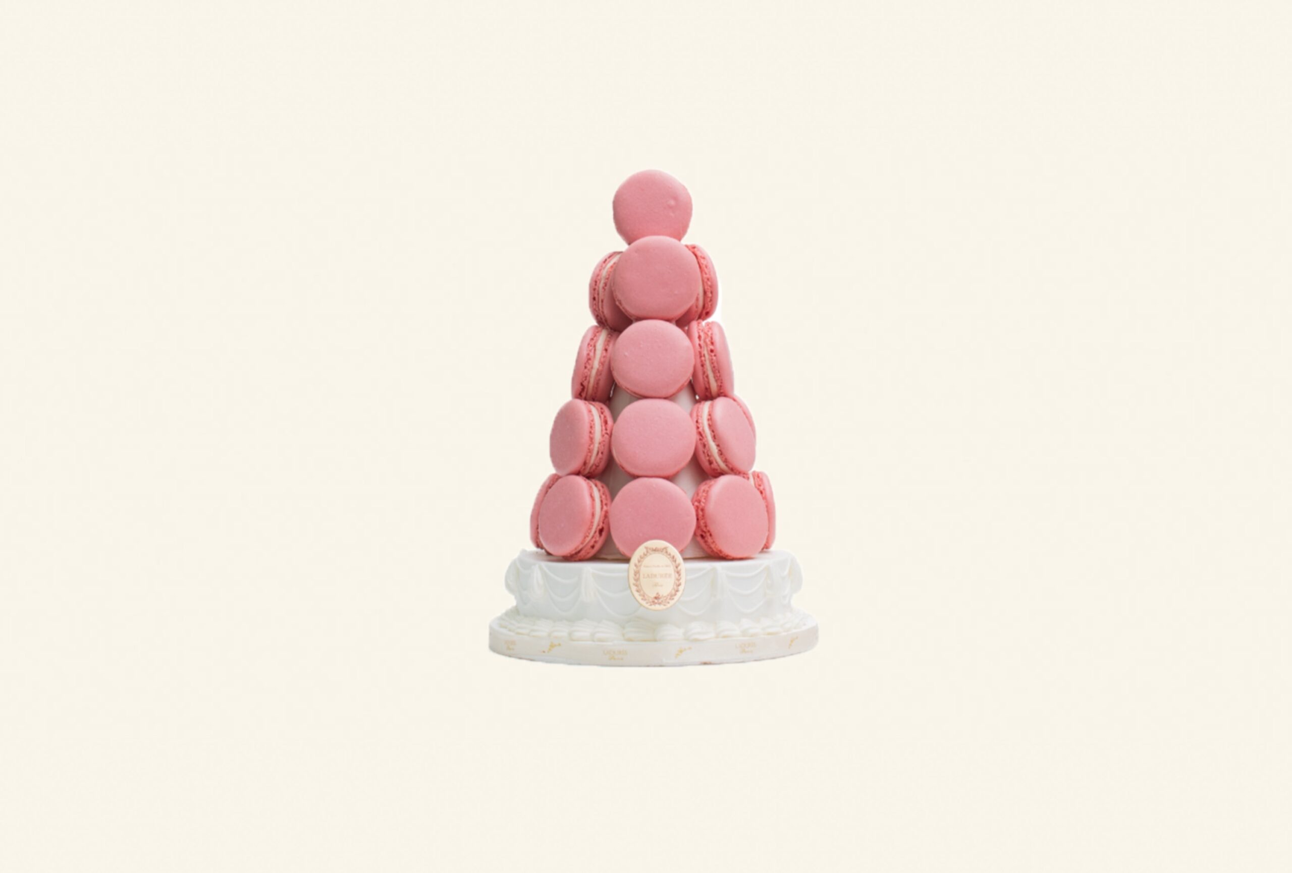 Pyramid of rose and ivory macarons on a porcelain stand, Ladurée
