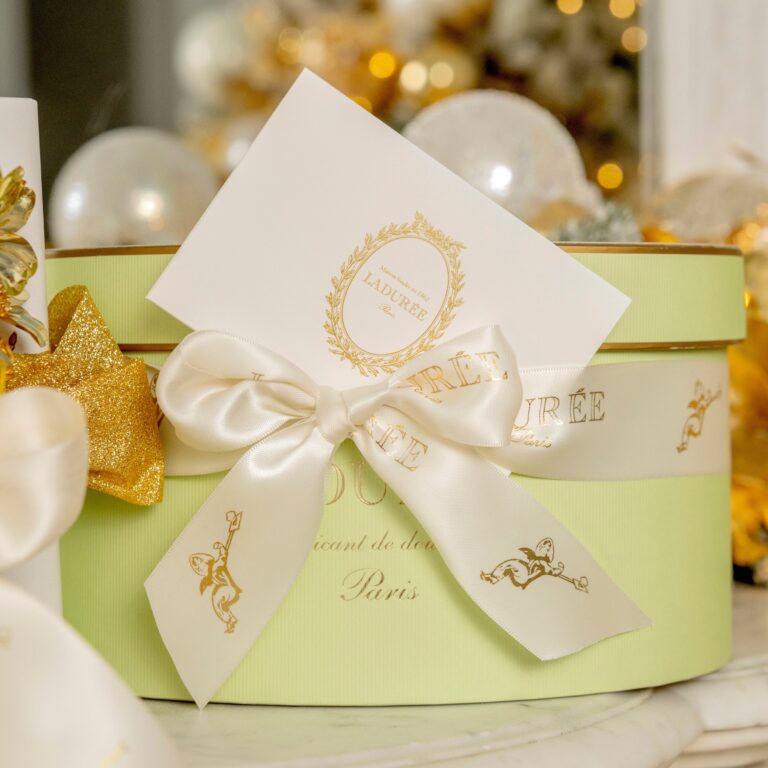 Hat box tied with a monogrammed ribbon and message card, Ladurée