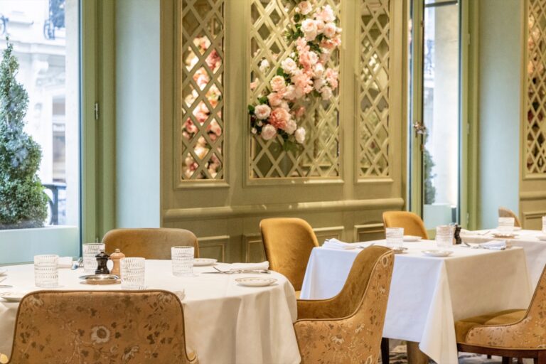 Private dining room with white linen and floral decoration, Ladurée