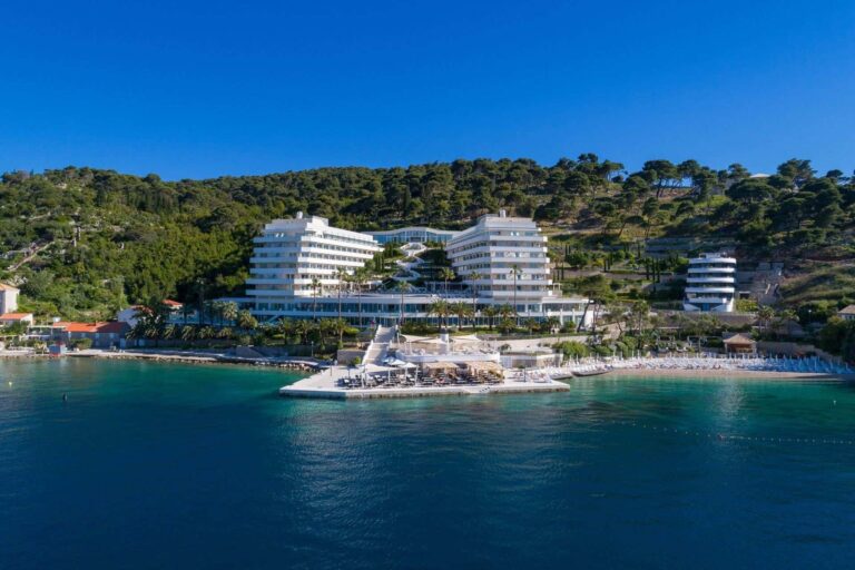 The resort from the sea, its private beach and sun terraces stretched along the shore, Lafodia Sea Resort
