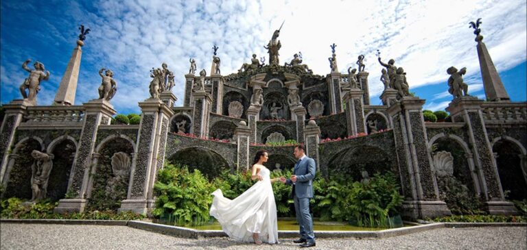 The couple before the baroque water theatre of statues and obelisks in the gardens of Isola Bella, Borromean Islands, Lake Maggiore & Tuscany Weddings