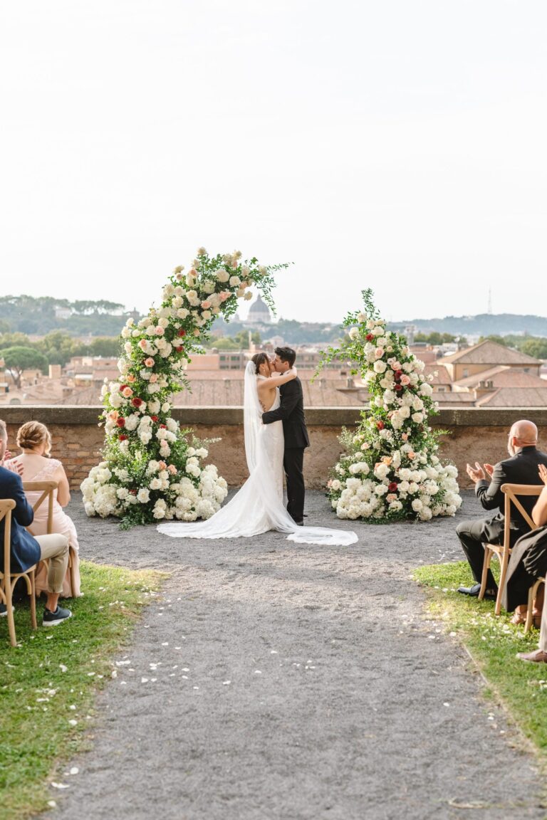 A ceremony on a terrace above Rome's rooftops, the couple between two columns of white and pink flowers, Le Rêve