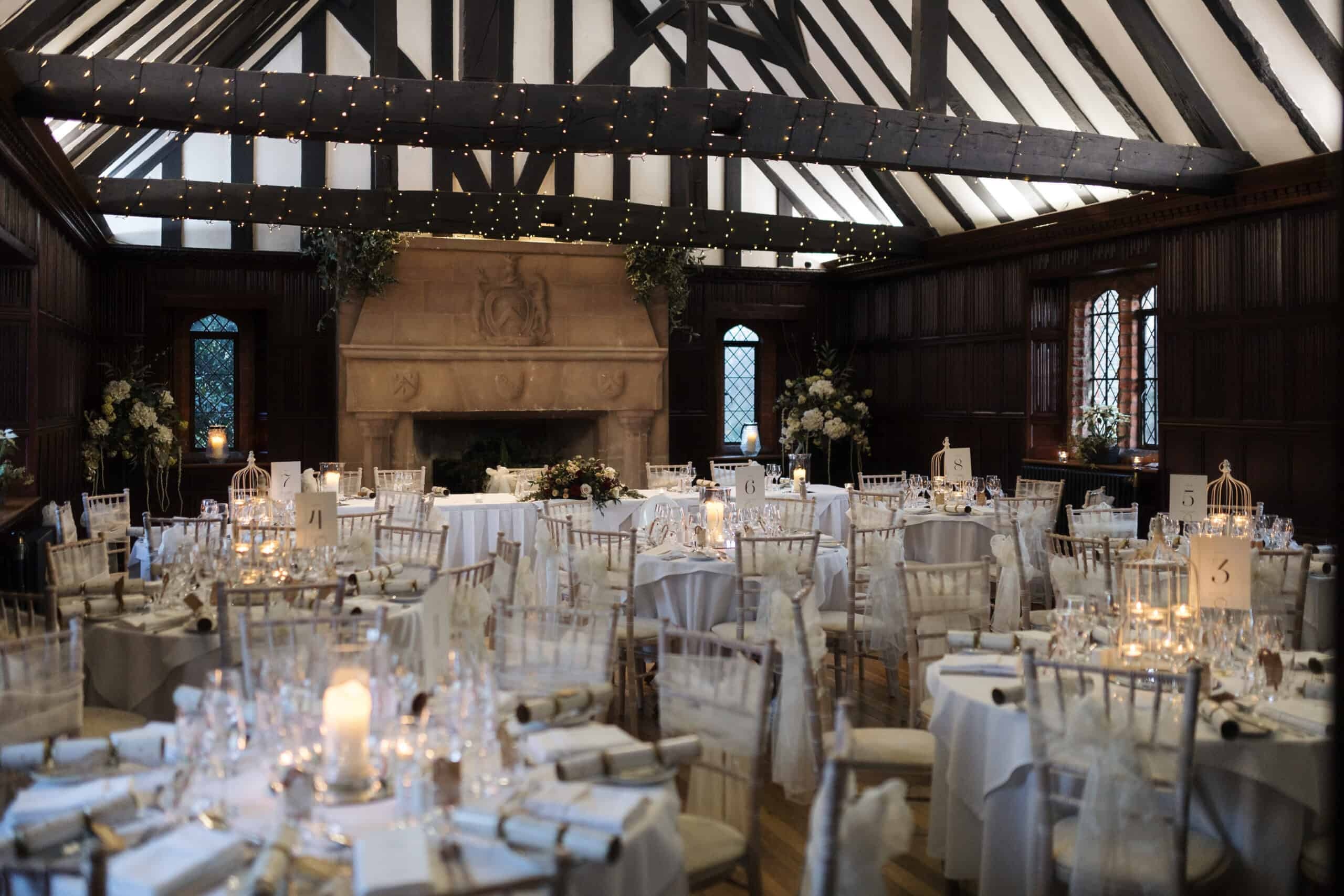 The Great Hall dressed for the wedding breakfast beneath its high timbered roof and stone fireplace, Leez Priory