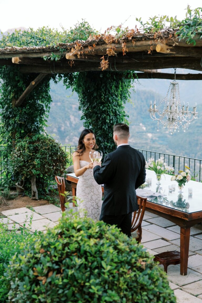 A toast under a vine pergola with a chandelier hung inside it, Leo Eventi