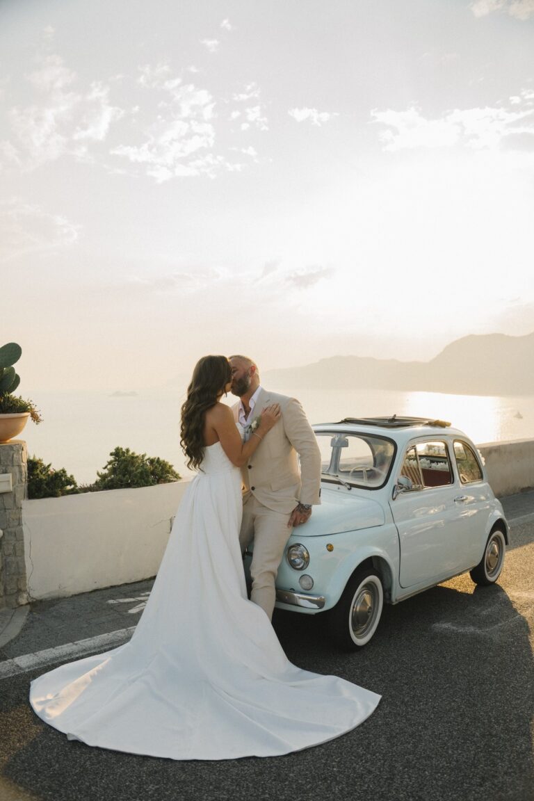 Beside a pale blue Fiat 500 on the road above Positano, Leo Eventi