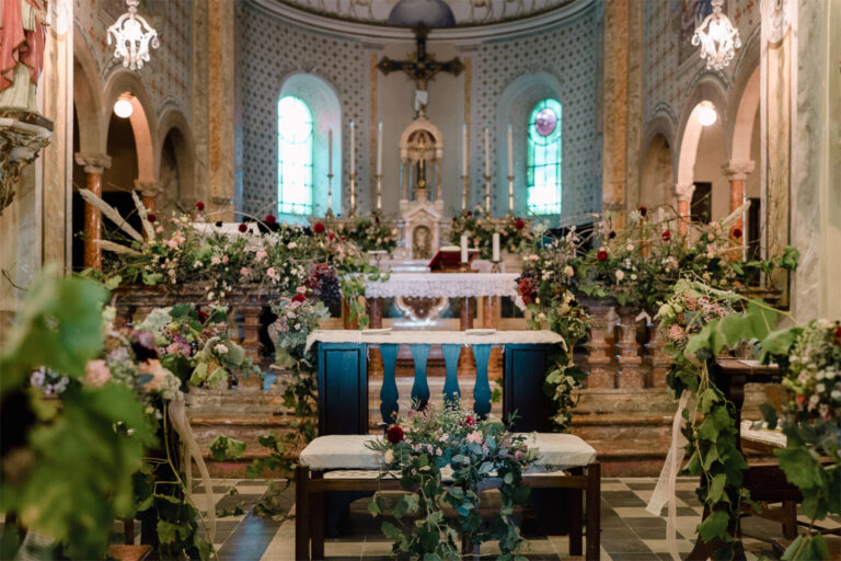 Village church dressed with garlands and loose flowers for a wedding ceremony, Letizia T. Events