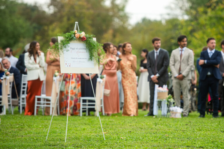 Guests gathered round a welcome board on the lawn before the ceremony, Letizia T. Events
