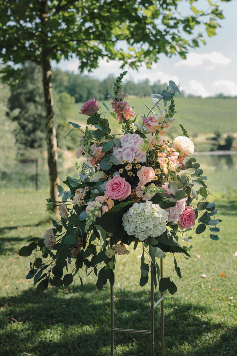 Tall hydrangea and rose arrangement beside a lakeside ceremony, Letizia T. Events