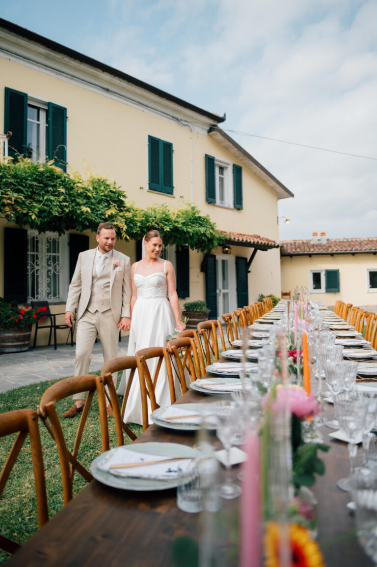 Long table laid on a villa terrace with pastel flowers and wooden chairs, Letizia T. Events