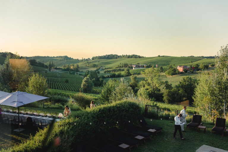 Rolling Piedmont vineyards at sunset above a wedding terrace, Letizia T. Events