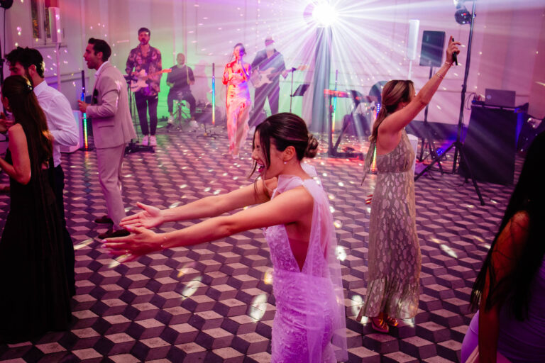 The bride and friends on the dance floor under the lights at Villa Aurelia, Rome, Light & Dreams