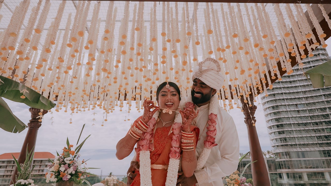 Vidhi and Arjun laughing under a floral canopy at Cinnamon Life, Colombo (film still), Lights and Magic