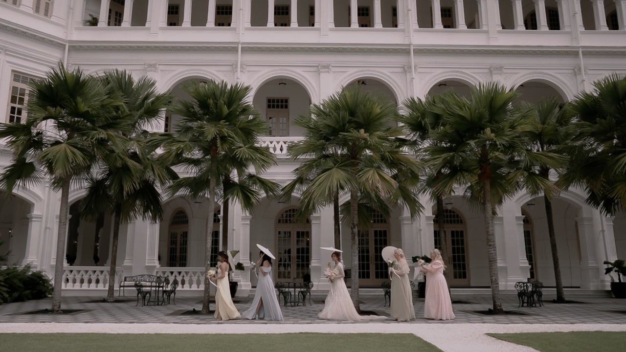 Tili and Martin's bridal party in the courtyard of Raffles Hotel, Singapore (film still), Lights and Magic