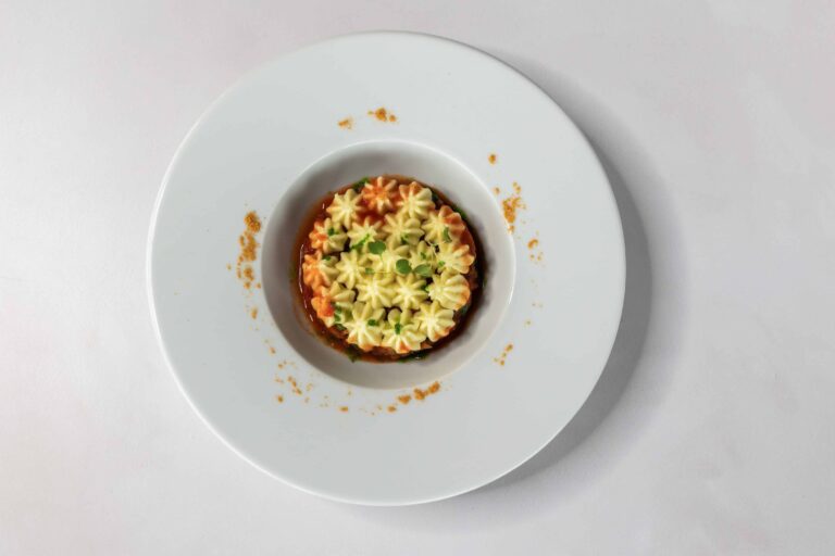 A plated dish with a piped golden topping, served in a wide white bowl, Lillibrooke Manor
