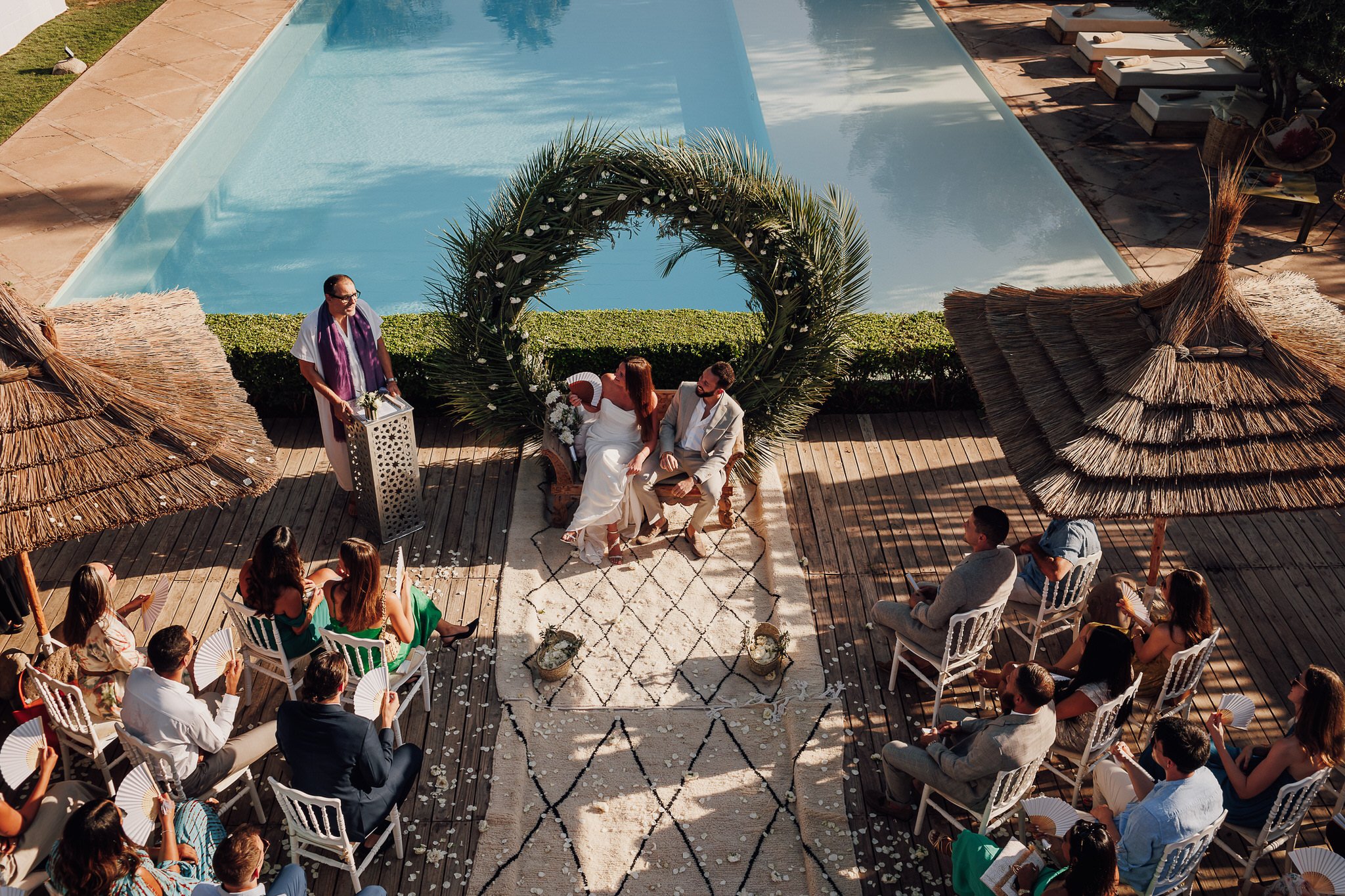 A poolside ceremony at Manzil La Tortue, Marrakech, seen from above, Lina + Tom Photography