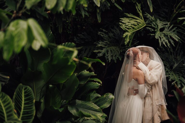 The couple under a veil among the palms, Kew Gardens, Lina + Tom Photography