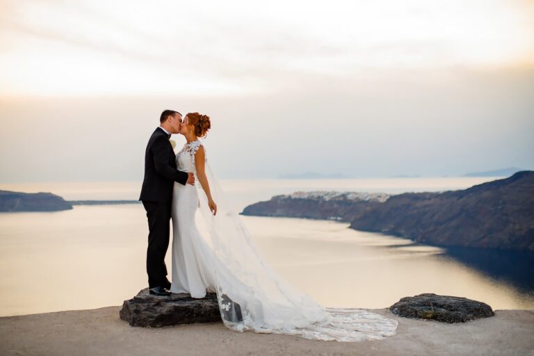 A clifftop kiss above the sea at sunset, Lina + Tom Photography