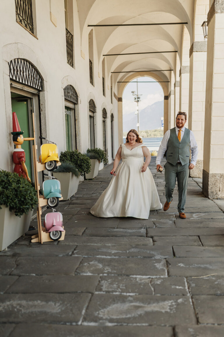 The couple walking under the lakeside arcades of Lovere, Lake Iseo, Lina + Tom Photography