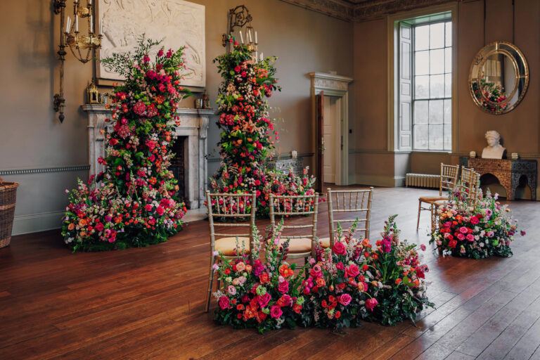 Pink and red floral columns dressing the ceremony room, Howsham Hall, Lina + Tom Photography
