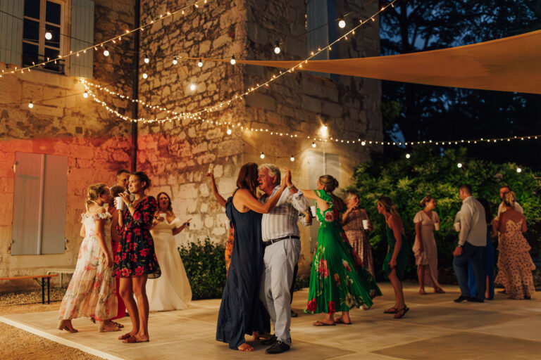 Guests dancing under festoon lights, Chateau Naudou, Lina + Tom Photography