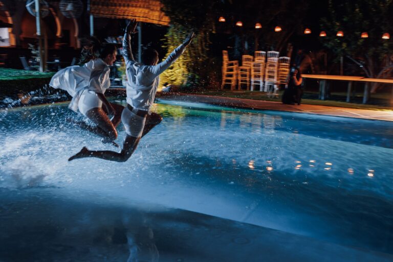 The couple leaping into the pool at the end of the night, Marrakech, Lina + Tom Photography