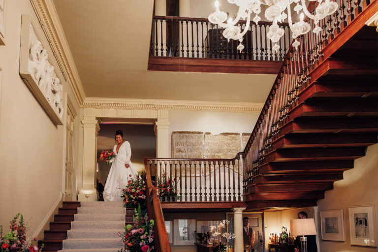 The bride at the foot of the great staircase, Howsham Hall, Lina + Tom Photography