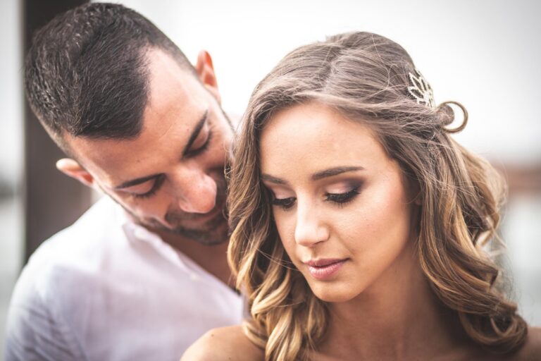 A bride and groom close together, a jewelled hairpin visible in her hair, Lisa Semenzato