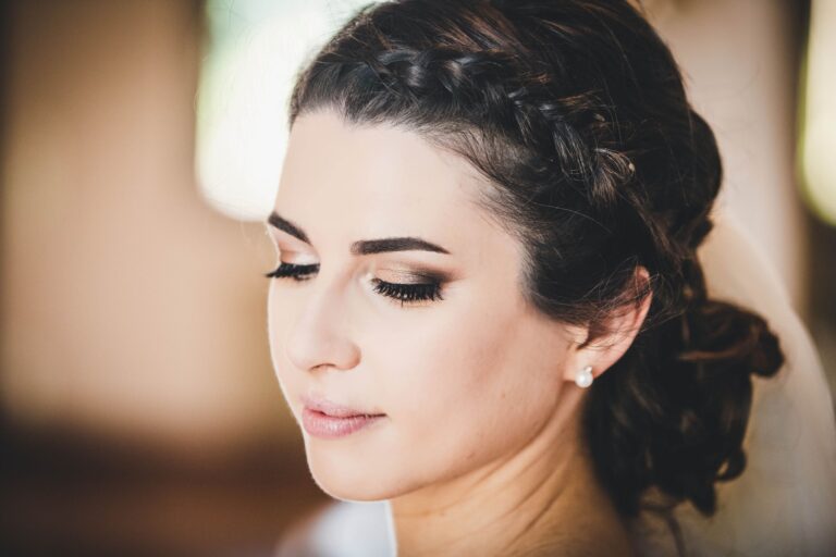 A bride in a braided crown updo, veiled in soft natural light, Lisa Semenzato