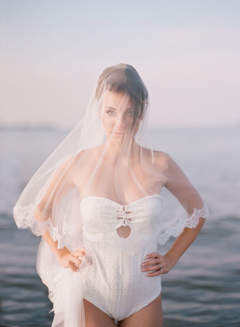 A bride in a veil at the water's edge, Lisa Semenzato