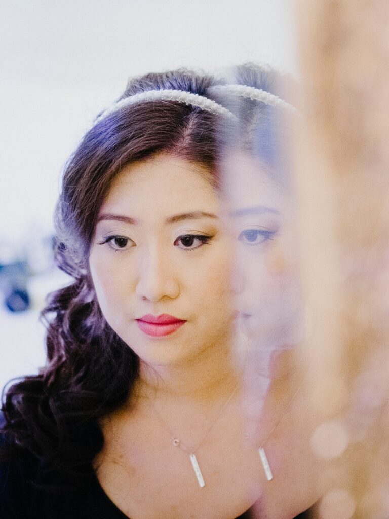 A bride's reflection in a mirror, crystal headband, black dress, Lisa Semenzato