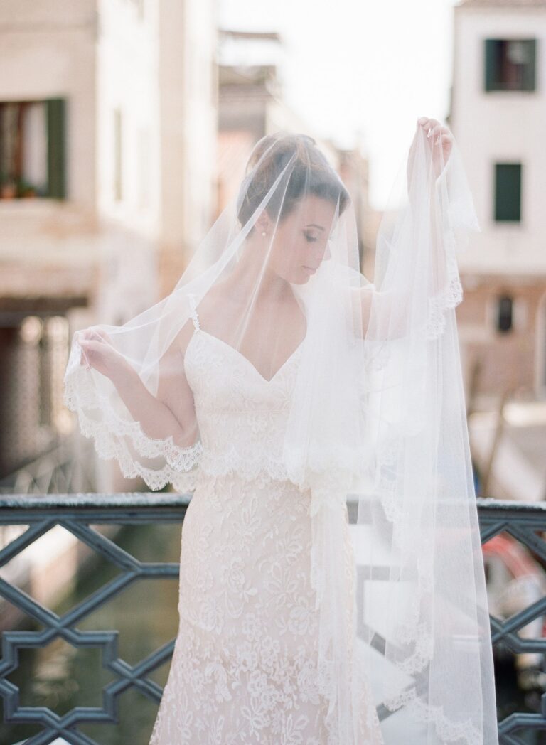 A bride on a Venice bridge, her veil lifted by the wind, Lisa Semenzato
