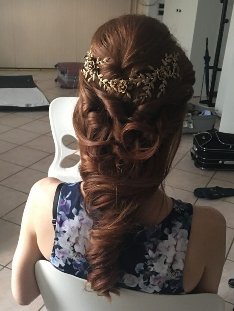 A half-up bridal style with a gold floral hairpiece, seen from behind, Lisa Semenzato