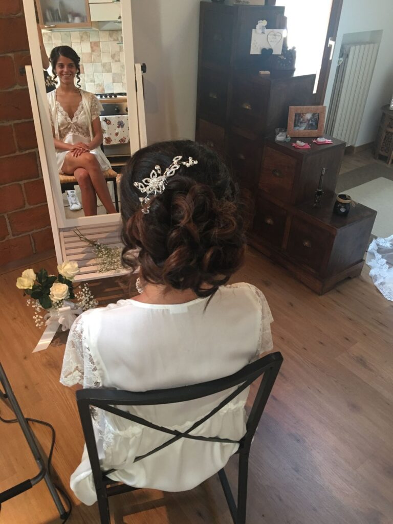 A bride in the mirror getting ready, an updo with a crystal hairpin, Lisa Semenzato