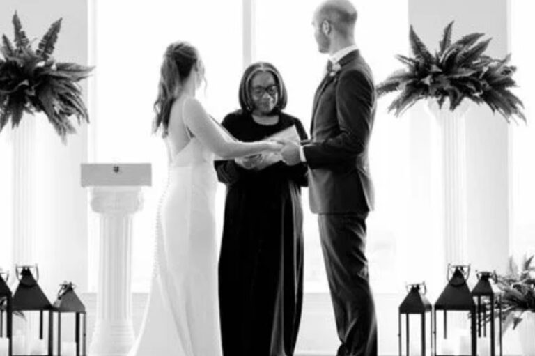 A black and white view of the couple facing the officiant, with ferns and lanterns either side, Living Ceremonies