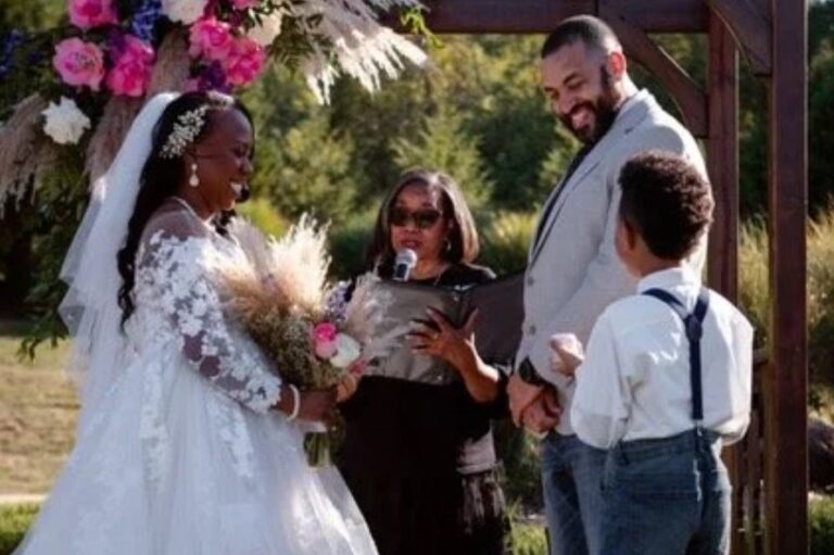 A bride and groom with the officiant and a young ring bearer during an outdoor ceremony, Living Ceremonies
