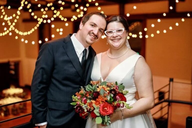 A couple with a bright bouquet beneath warm string lights, Living Ceremonies