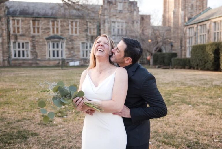 A couple laughing on a lawn in front of a historic stone building, Living Ceremonies