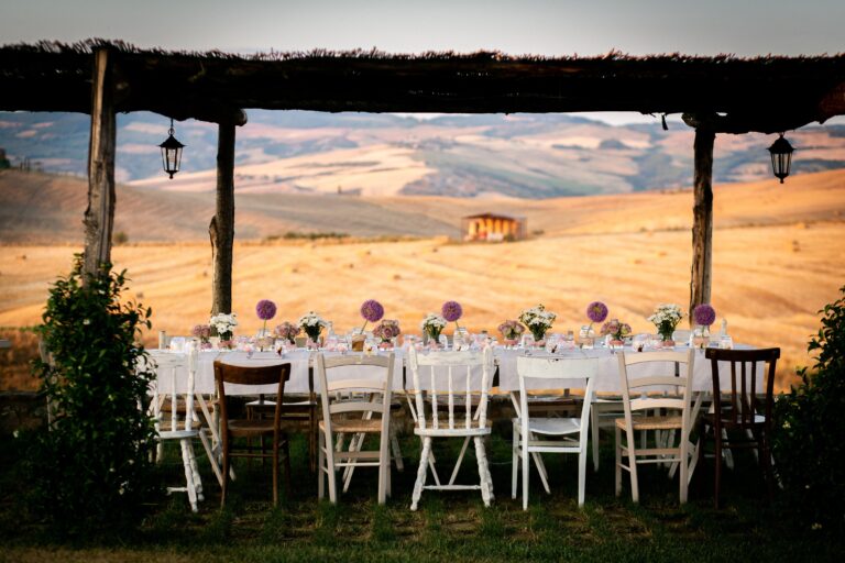 A long table beneath the pergola, looking out over the golden fields, Locanda in Tuscany