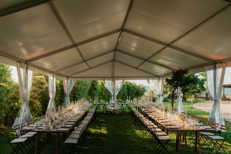 A marquee over long tables on the lawn, Locanda in Tuscany