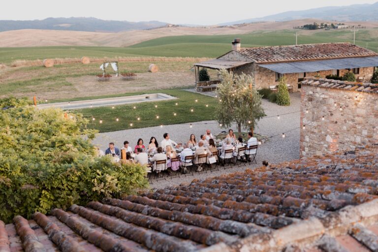 A wedding dinner in the courtyard, seen across the terracotta roof tiles, Locanda in Tuscany