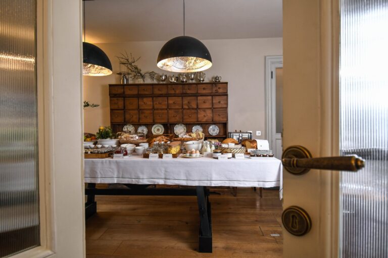 A breakfast table seen through a half-open door, Locanda La Raia