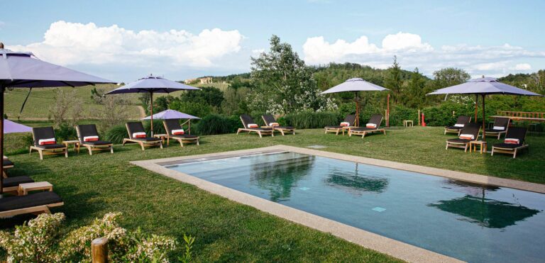 The swimming pool and lawn, with sun loungers and parasols, Locanda La Raia