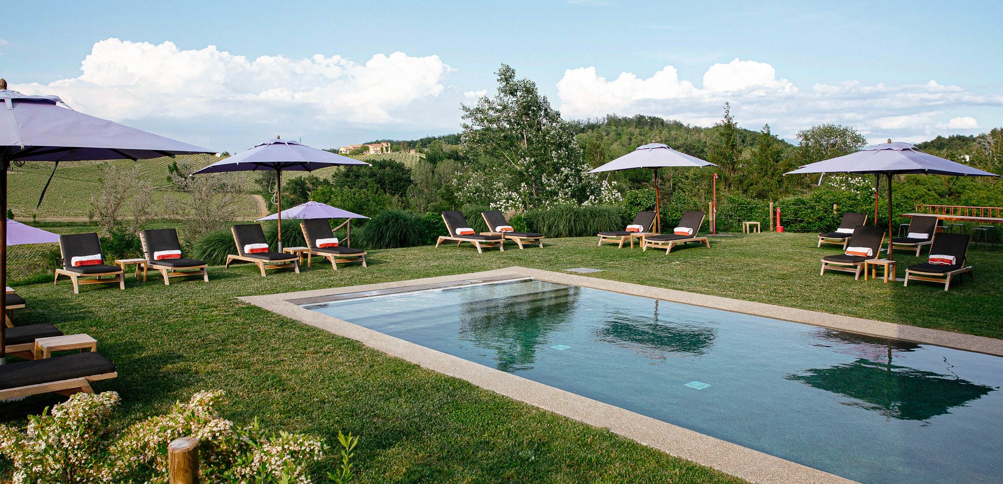 The swimming pool and lawn, with sun loungers and parasols, Locanda La Raia