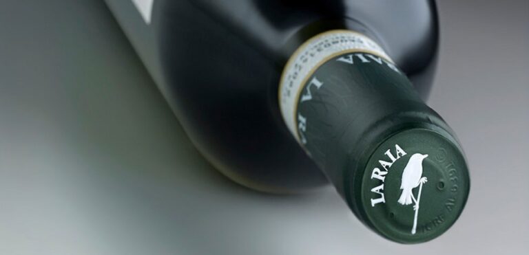 A bottle of La Raia wine, its label showing the estate's bird mark, Locanda La Raia