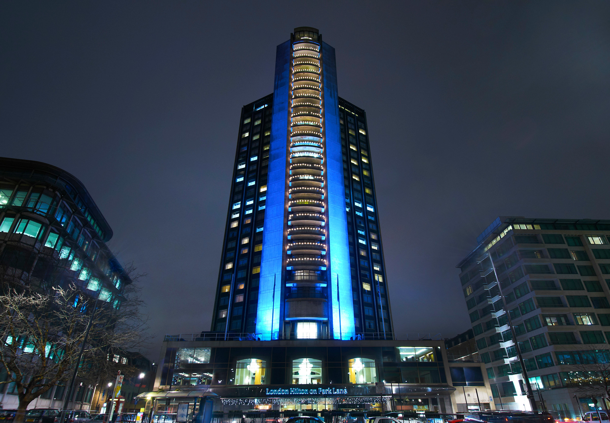 The tower on Park Lane lit blue at night, London Hilton on Park Lane