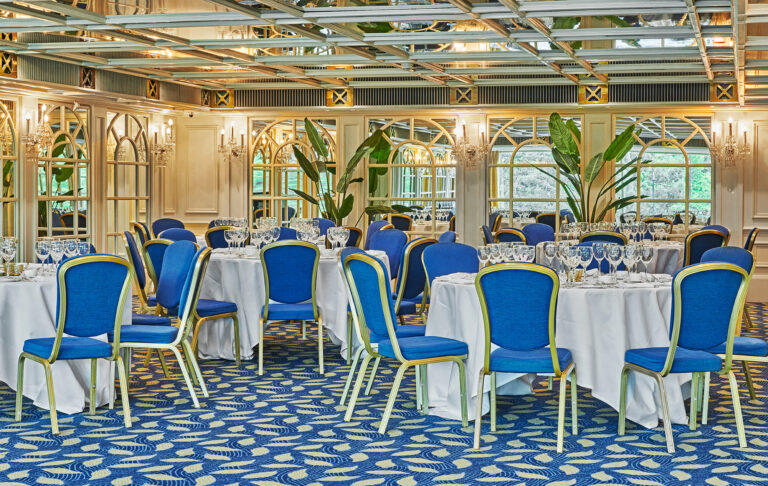 A ballroom laid with round tables for a seated dinner, London Hilton on Park Lane