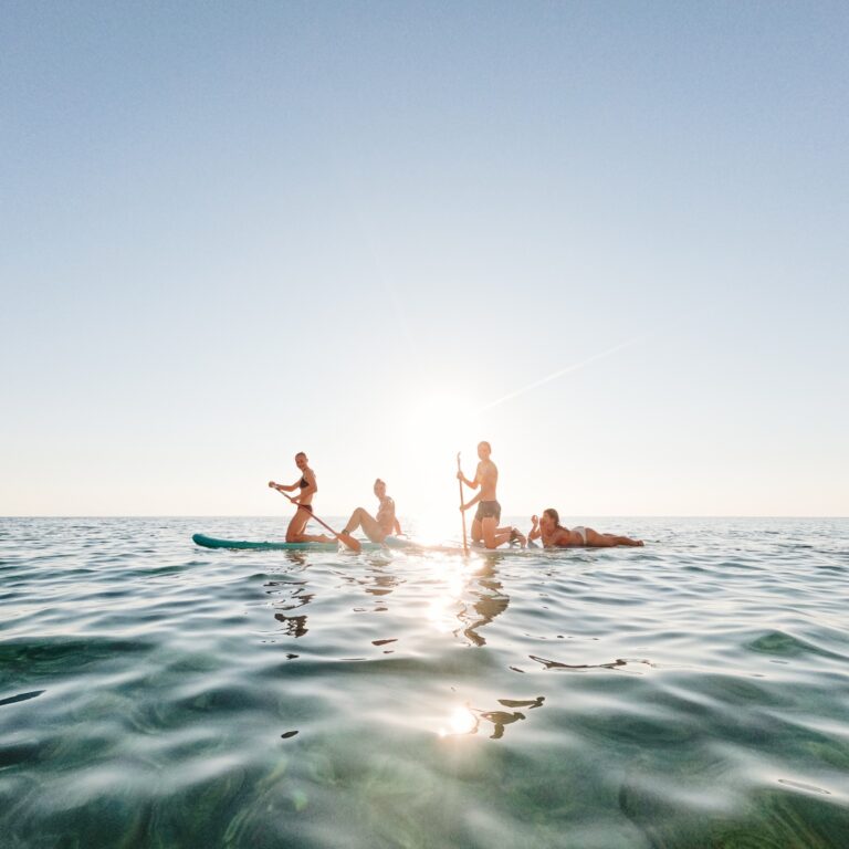 Paddleboarding on calm water, Long Bay Beach Resort