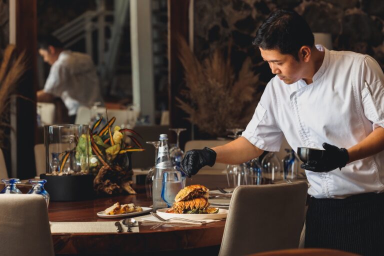Chef plating a dish in the restaurant, Long Bay Beach Resort