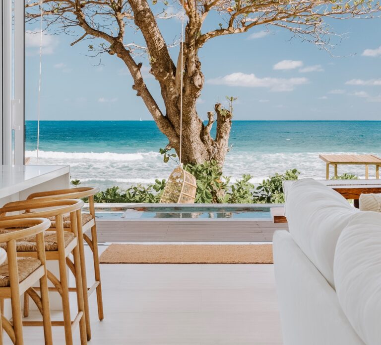 Beach house with a seating area over the sea, Long Bay Beach Resort